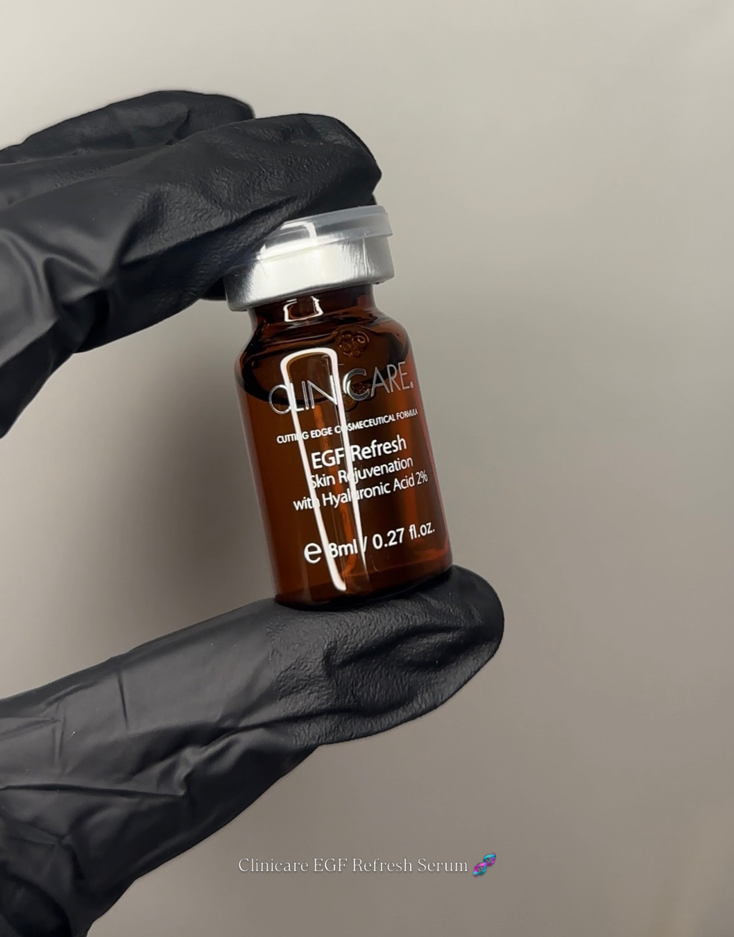 A gloved hand holding a vial of EGF Refresh skin rejuvenation serum