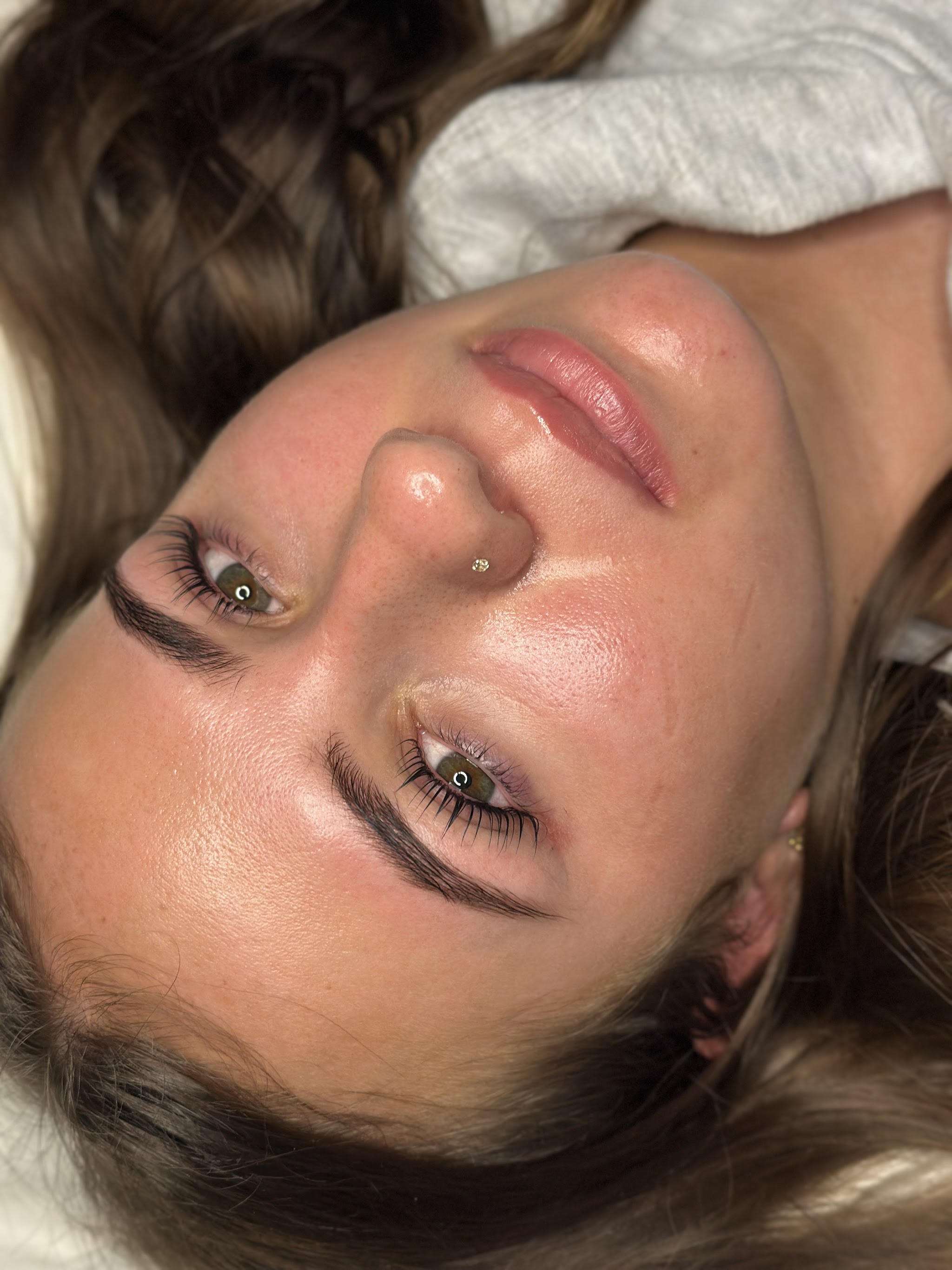 Close-up of glowing skin and lifted lashes