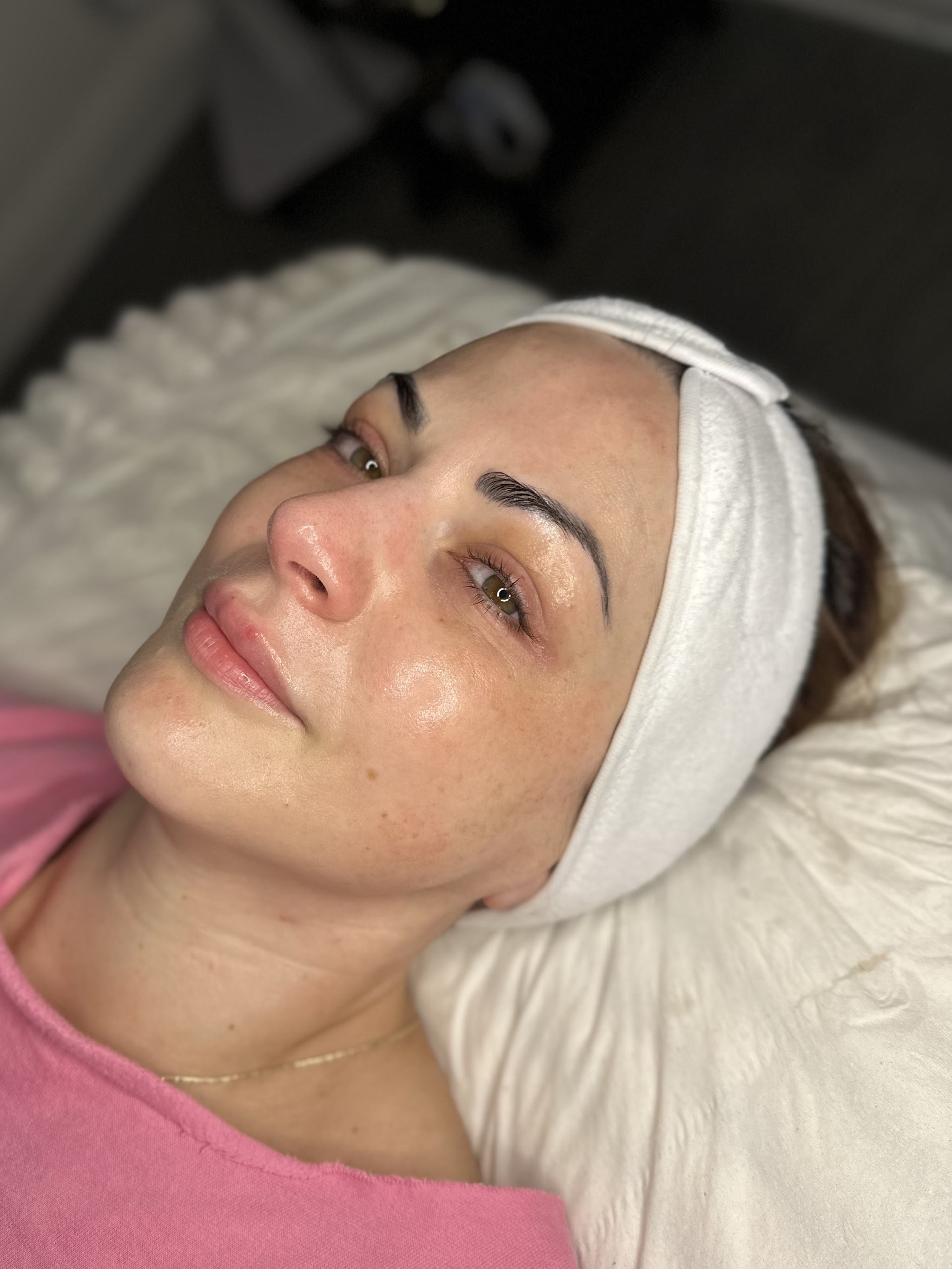 A client relaxing on the heated treatment bed after her facial