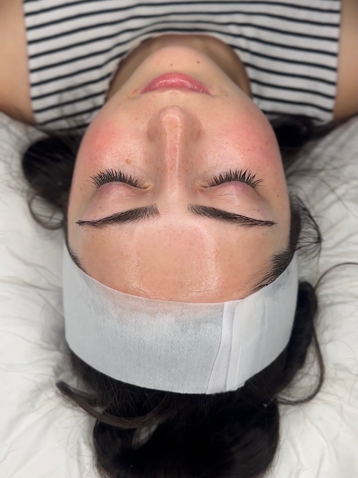 Lifted lashes and glowing skin after a facial